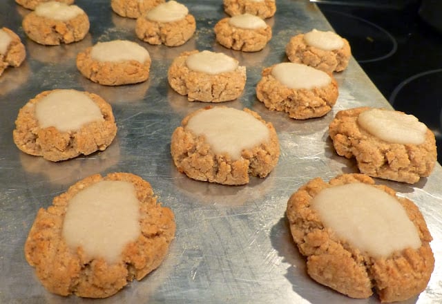 A tray of ginger cookies with coconut icing. 