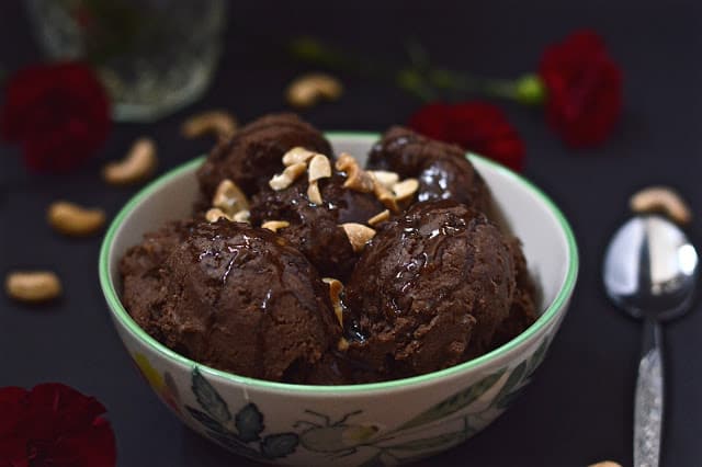 A bowl of dairy free chocolate mocha ice cream toped with peanuts. 