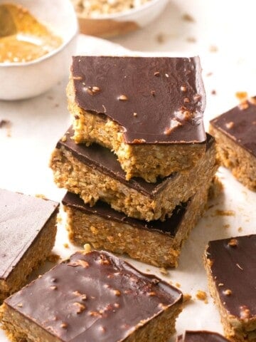 A stack of chocolate almond butter bars and the top one has a bite out of it.