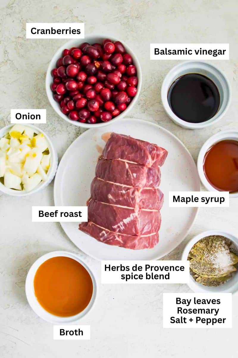 Different foods separated into bowls including a beef roast, cranberries, chopped onion, maple syrup and spices.
