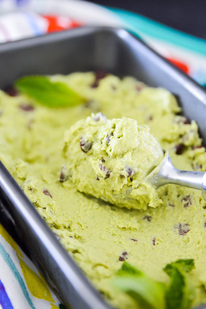 A scoop of avocado mint chocolate chip ice cream.