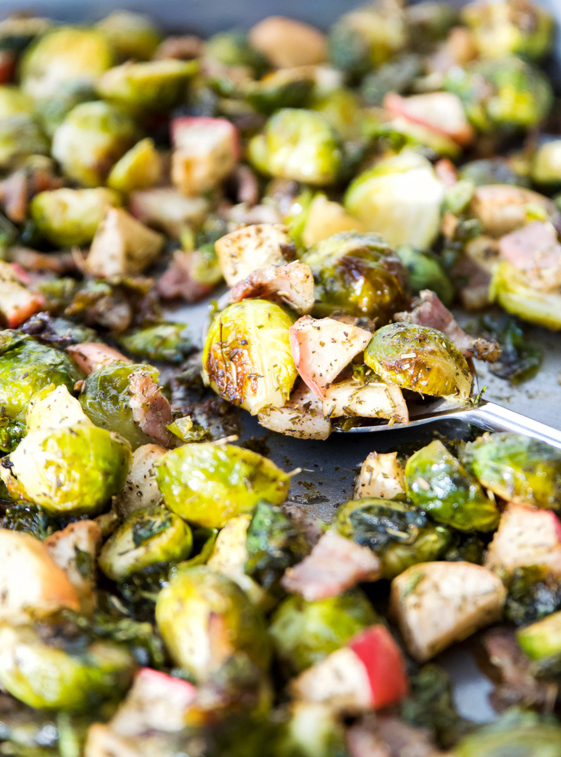 A pan full of roasted Brussels sprouts with bacon and apples 