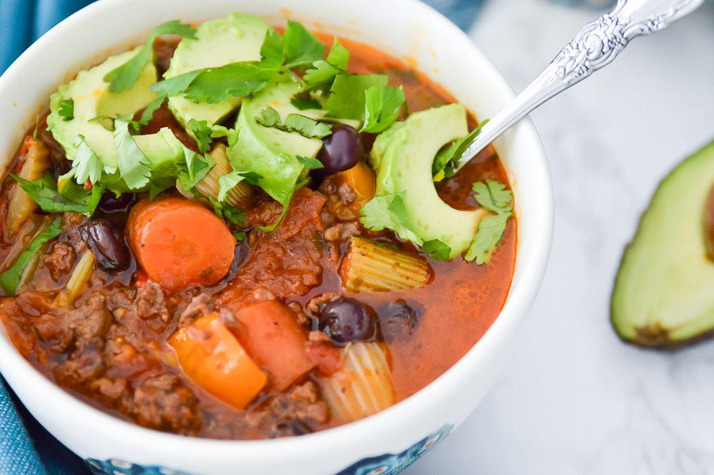 Large bowl of paleo chili with blueberries