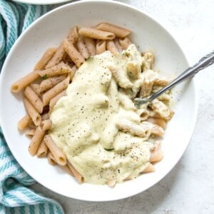A bowl of pasta with cauliflower Alfredo sauce on it.