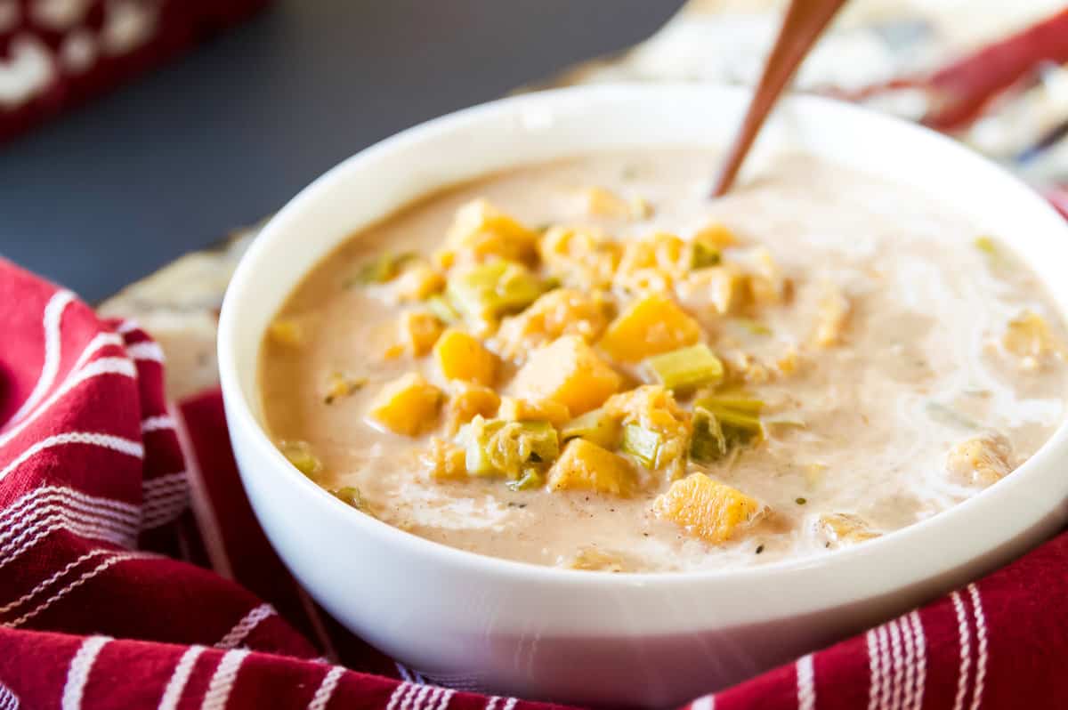 Bowl of Whole30 Coconut Squash Soup with a spoon