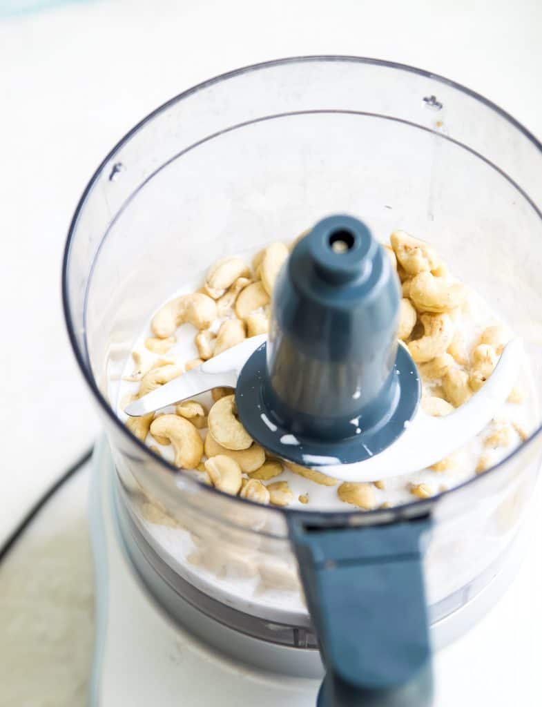 Raw cashews and coconut milk in a food processor 