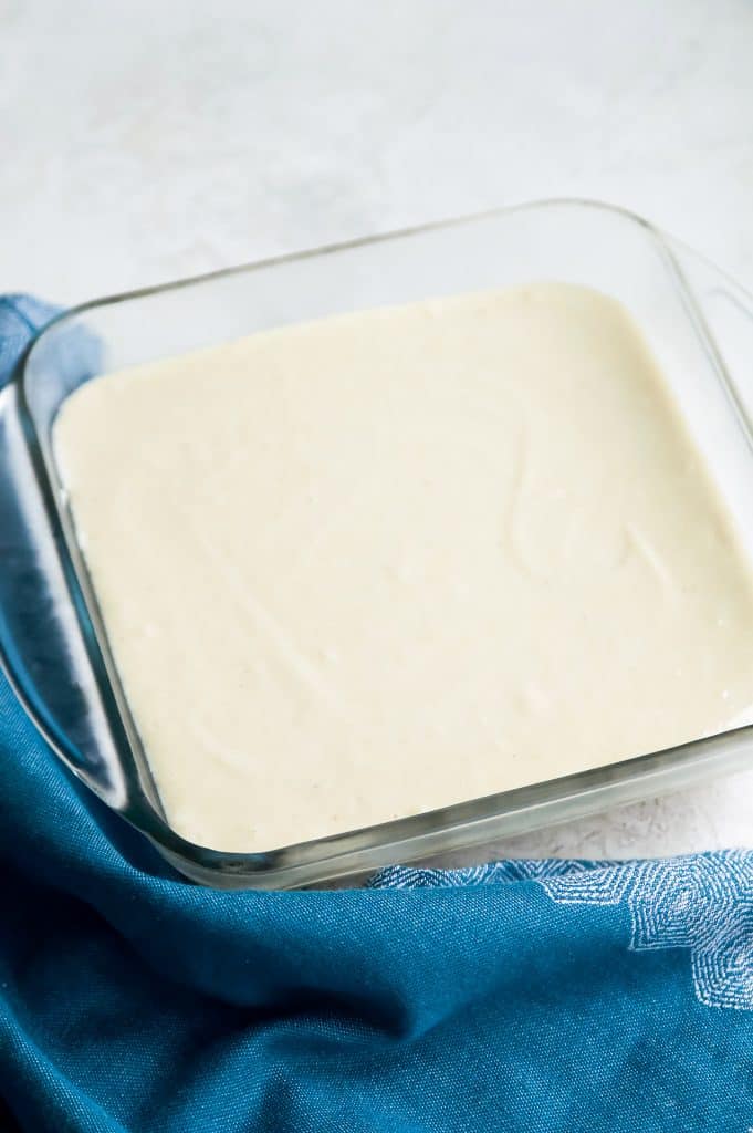 A glass baking dish with a layer of paleo vanilla ice cream.