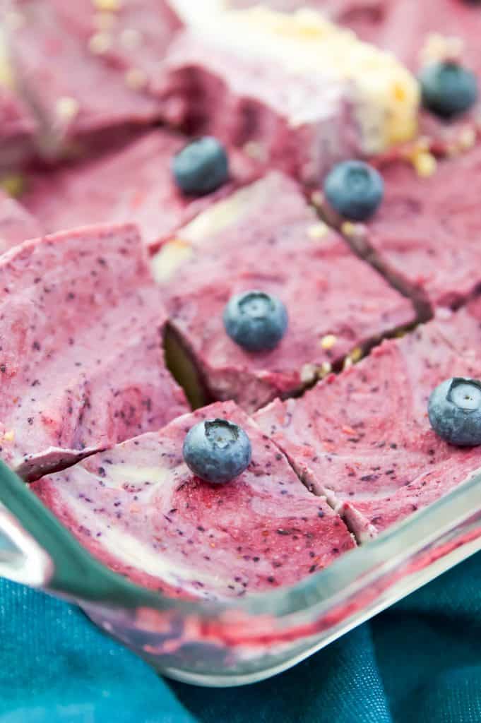 Close up shot of paleo ice cream bars with berries in a glass baking dish