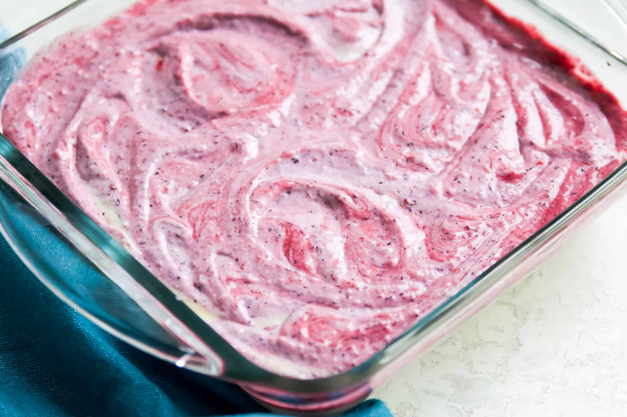 A pan of paleo ice cream bars with berries. 