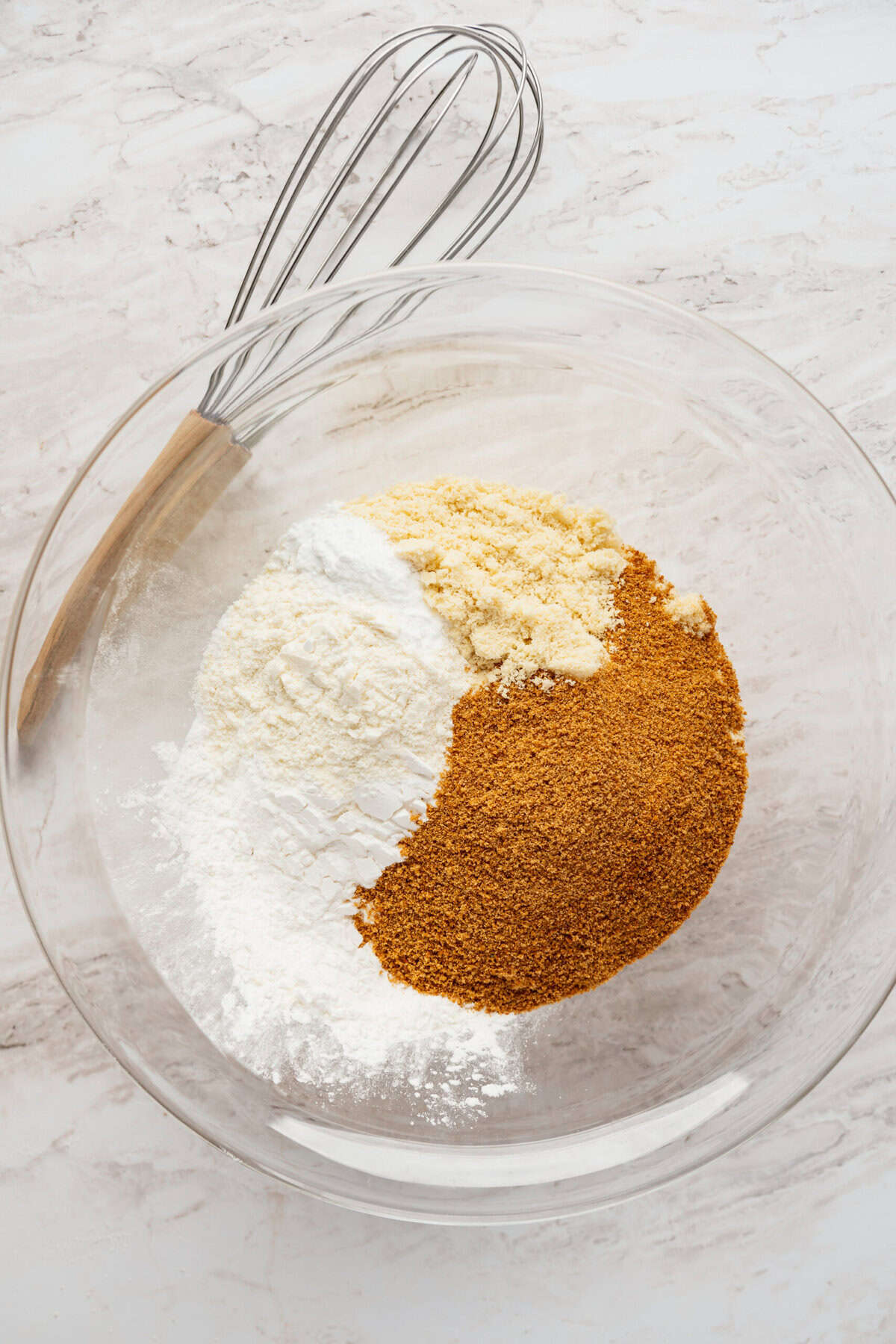 A glass bowl filled with coconut sugar and flour.