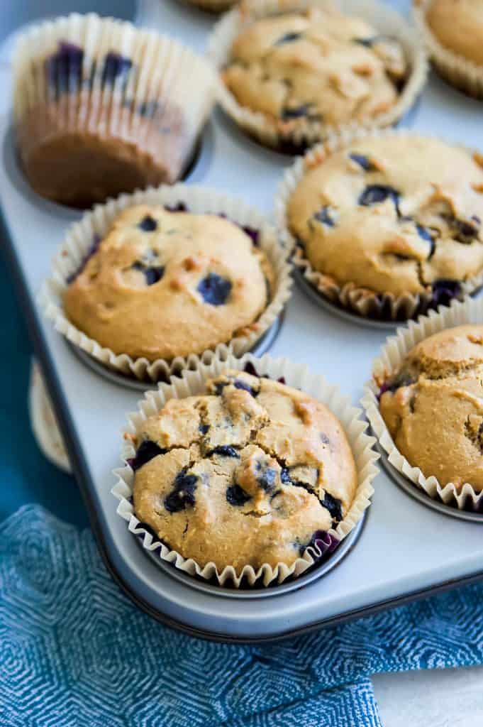 A muffin tray full of gluten free blueberry muffins.
