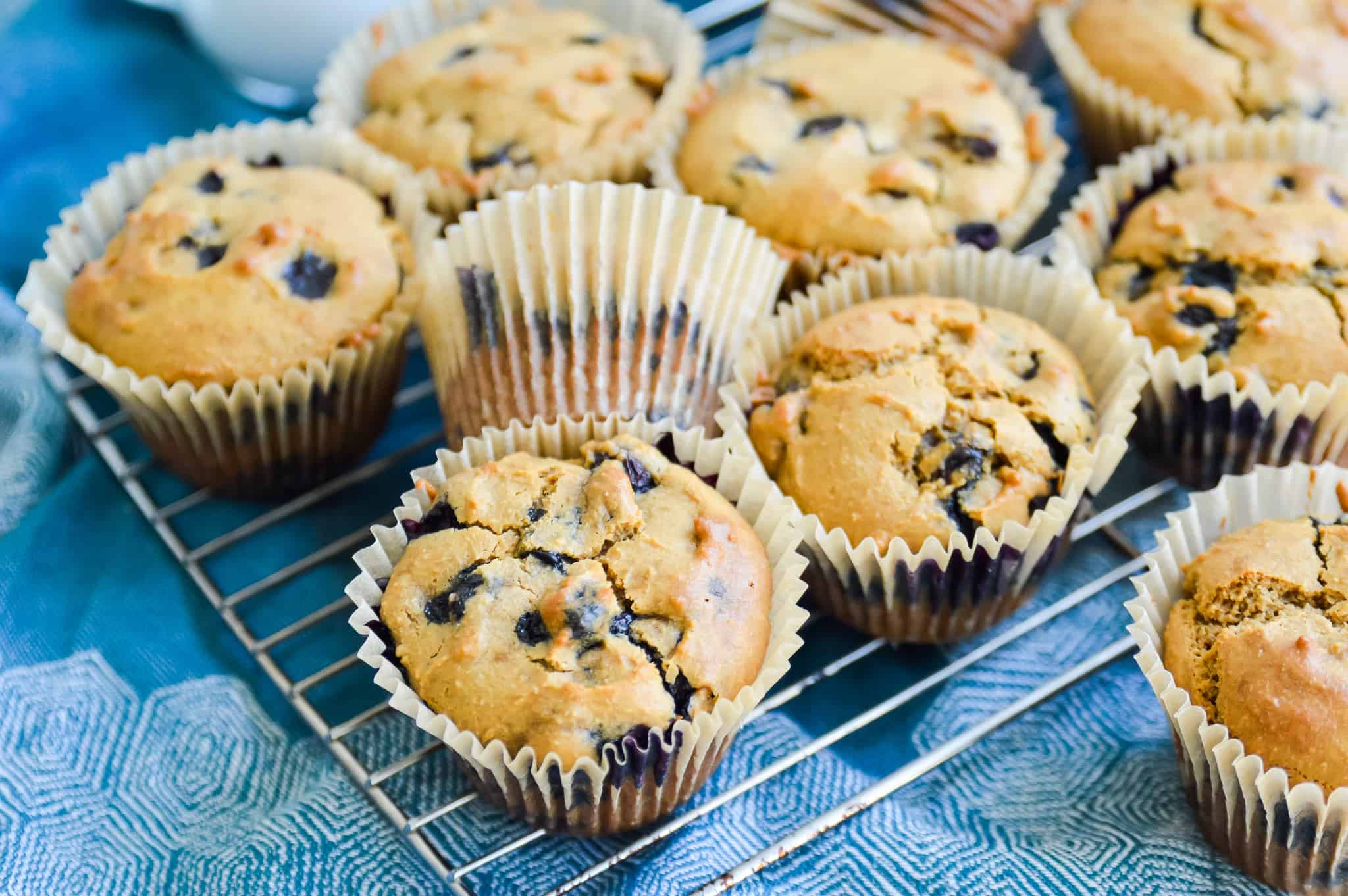 Gluten free blueberry muffins on a baking rack.