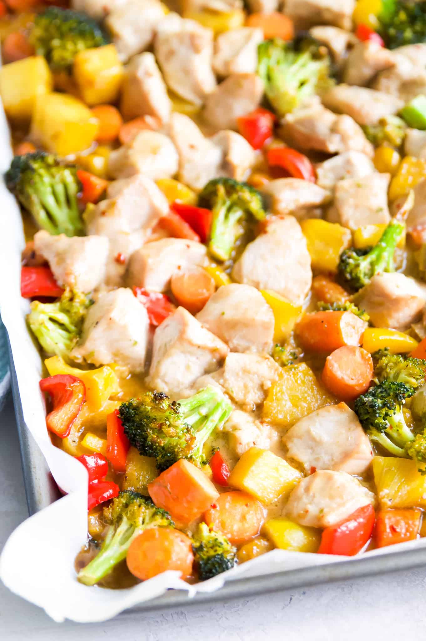 A tray of teriyaki chicken stir fry  with broccoli, peppers and pineapple.