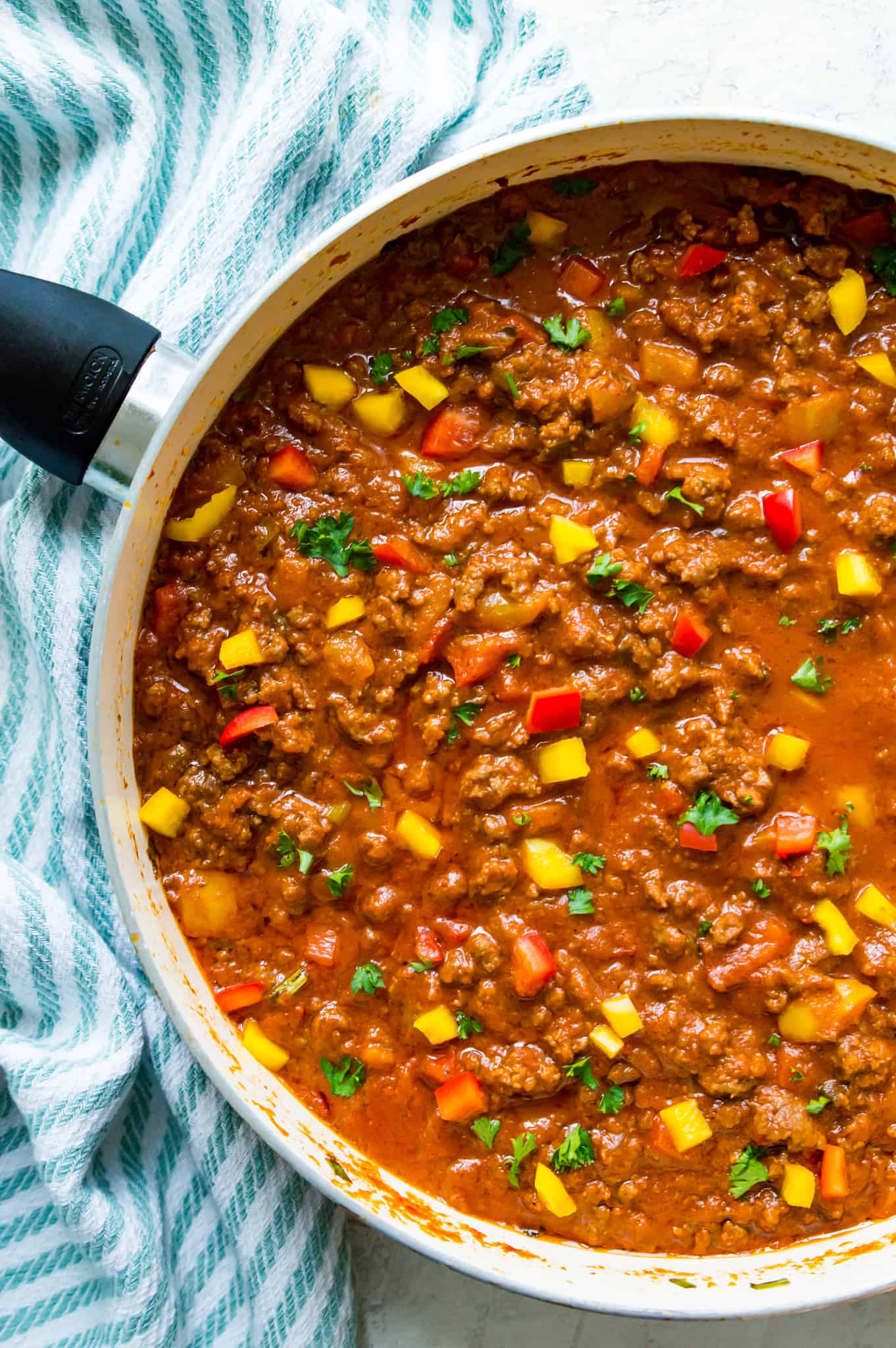 A pan of Whole30 sloppy joes garnished with fresh parsley.