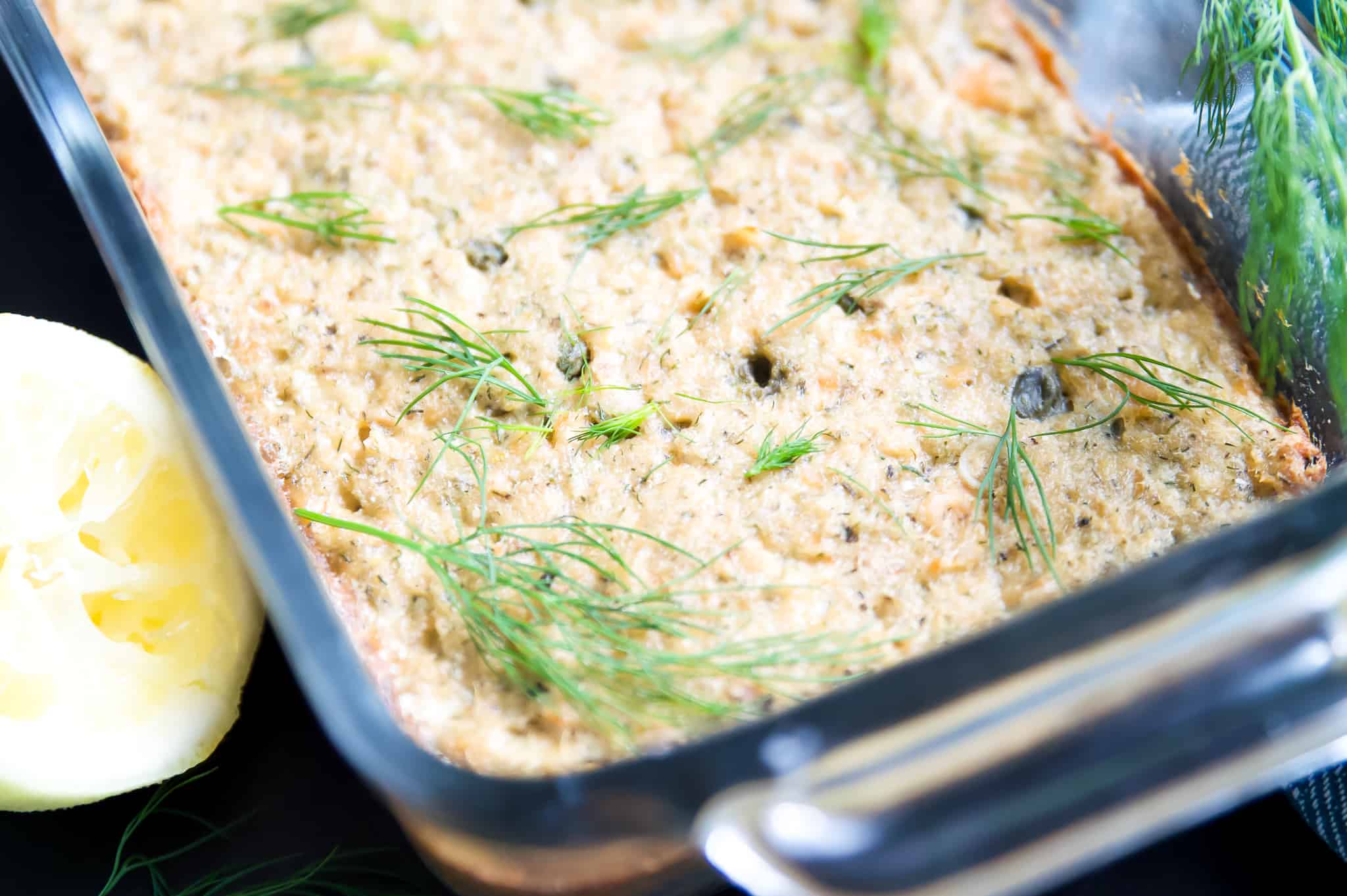 A salmon loaf with fresh dill on top for garnish.