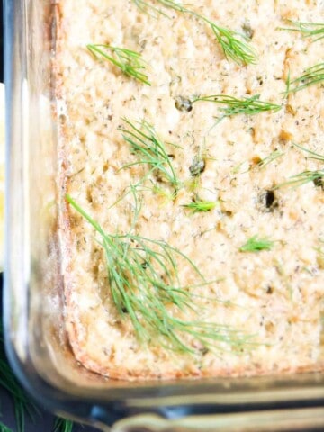 A cooked salmon loaf topped with fresh dill.