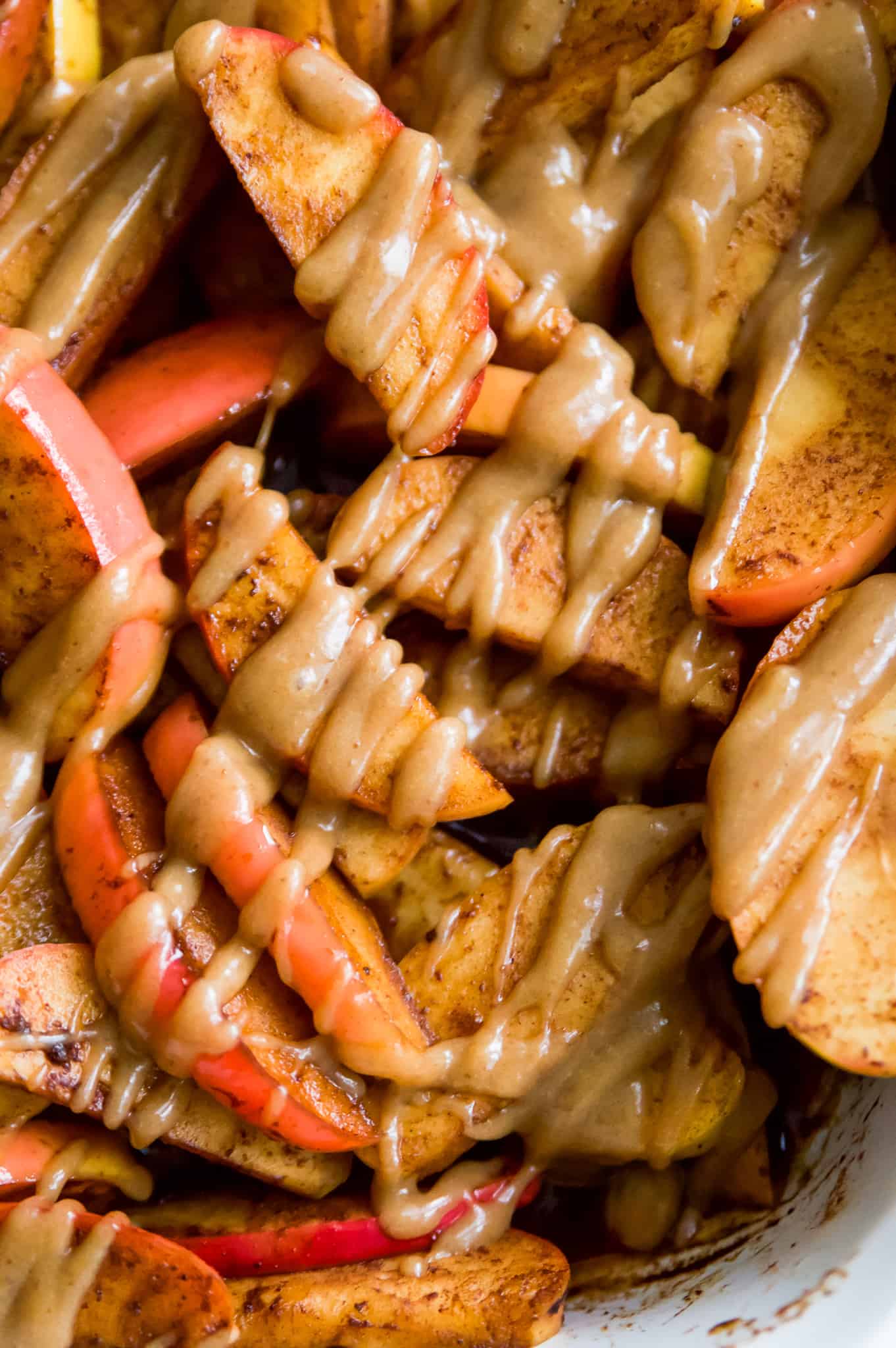 Baked apple slices with caramel drizzled on top.