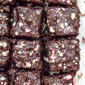 Peppermint brownies cut into pieces and topped with crushed candy canes.
