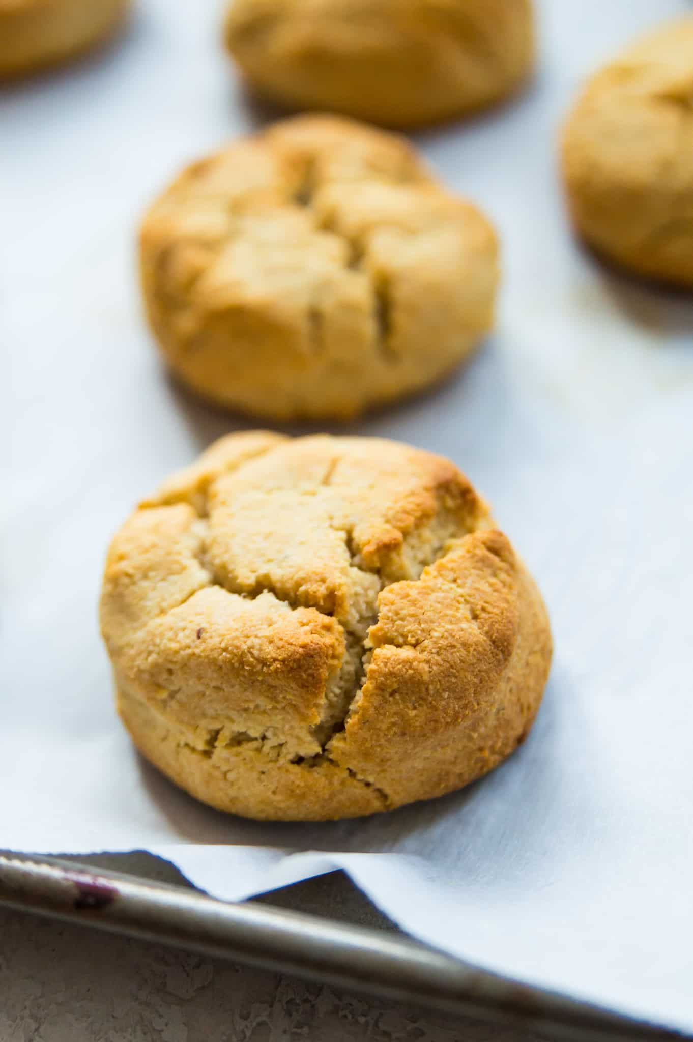 A tray of almond flour biscuits lined with parchment paper.