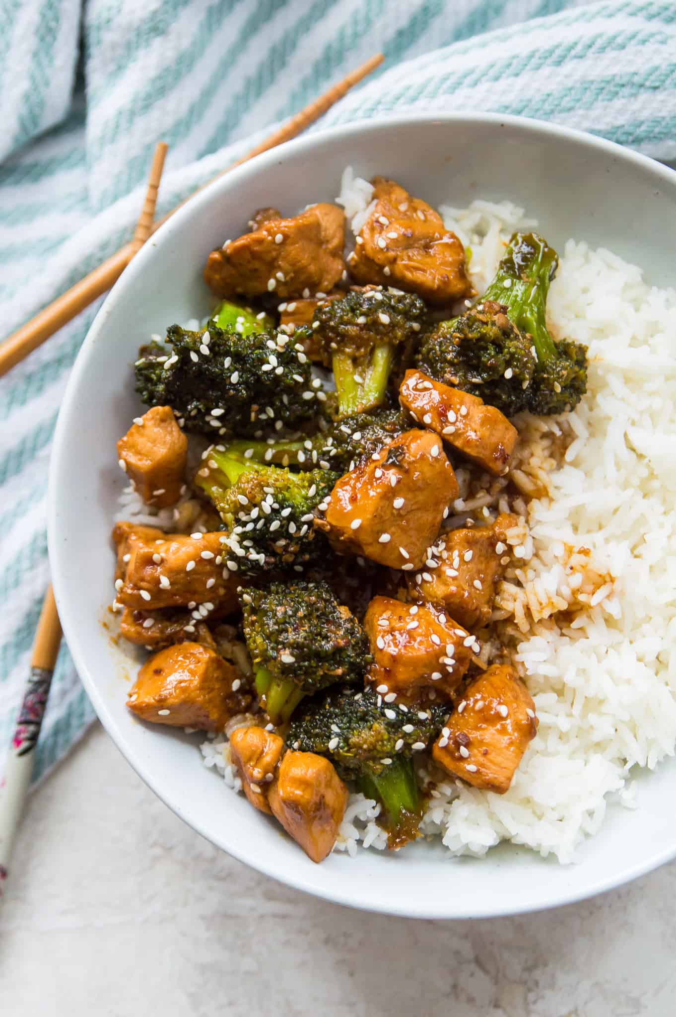 A bowl of teriyaki chicken and broccoli over white rice. 