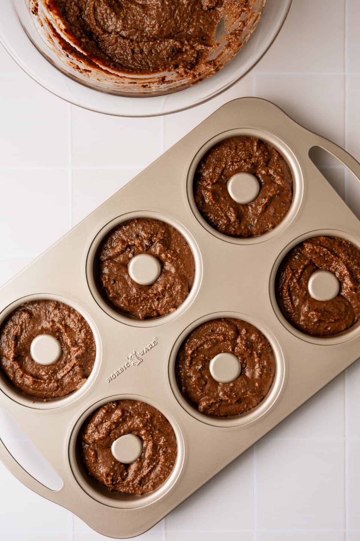 A donut mold filled with chocolate batter.