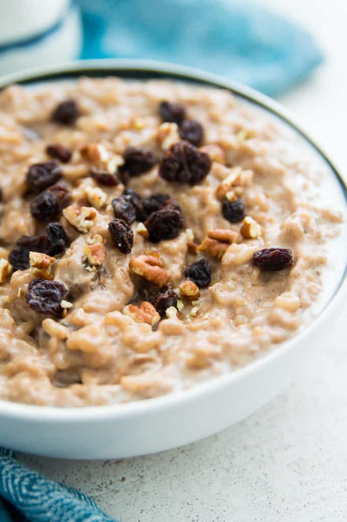 A bowl of rice pudding with raisins and pecans