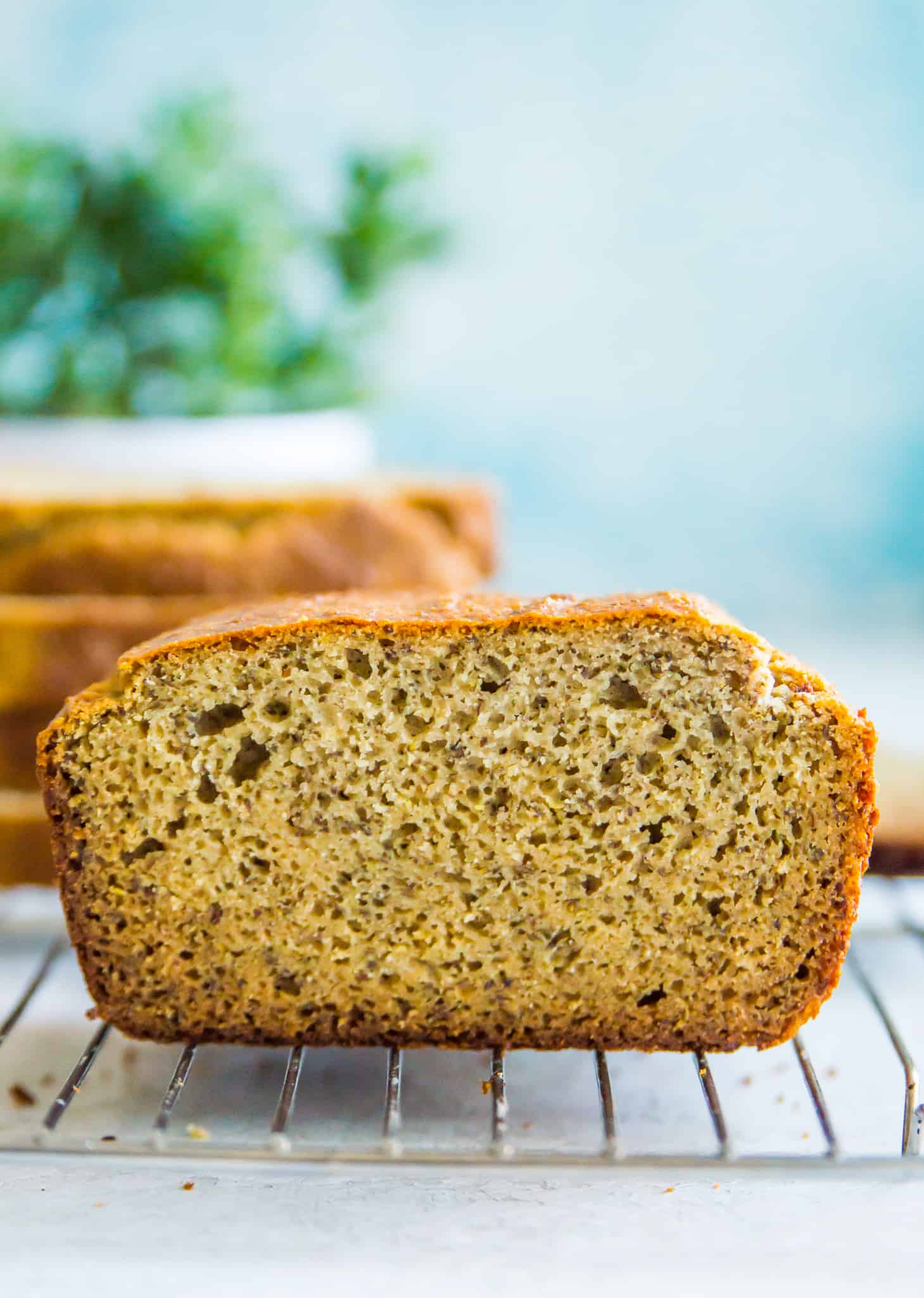 a loaf of paleo bread that has been cut in half and placed on a baking rack.