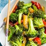 A bowl of broccoli and peppers with teriyaki sauce