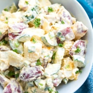 A bowl of Whole30 potato salad topped with fresh parsley.