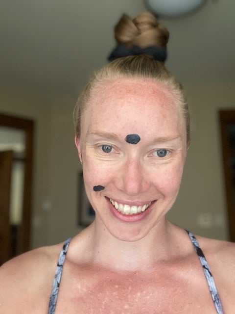 Erin Carter with the Beautycounter charcoal mask on her face as a spot treatment.