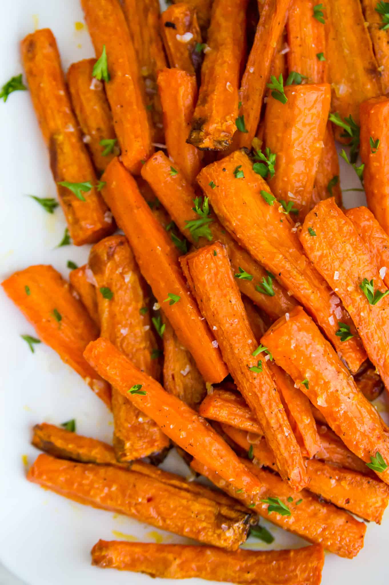 A tray of air fryer carrots with salt and parsley on top. 