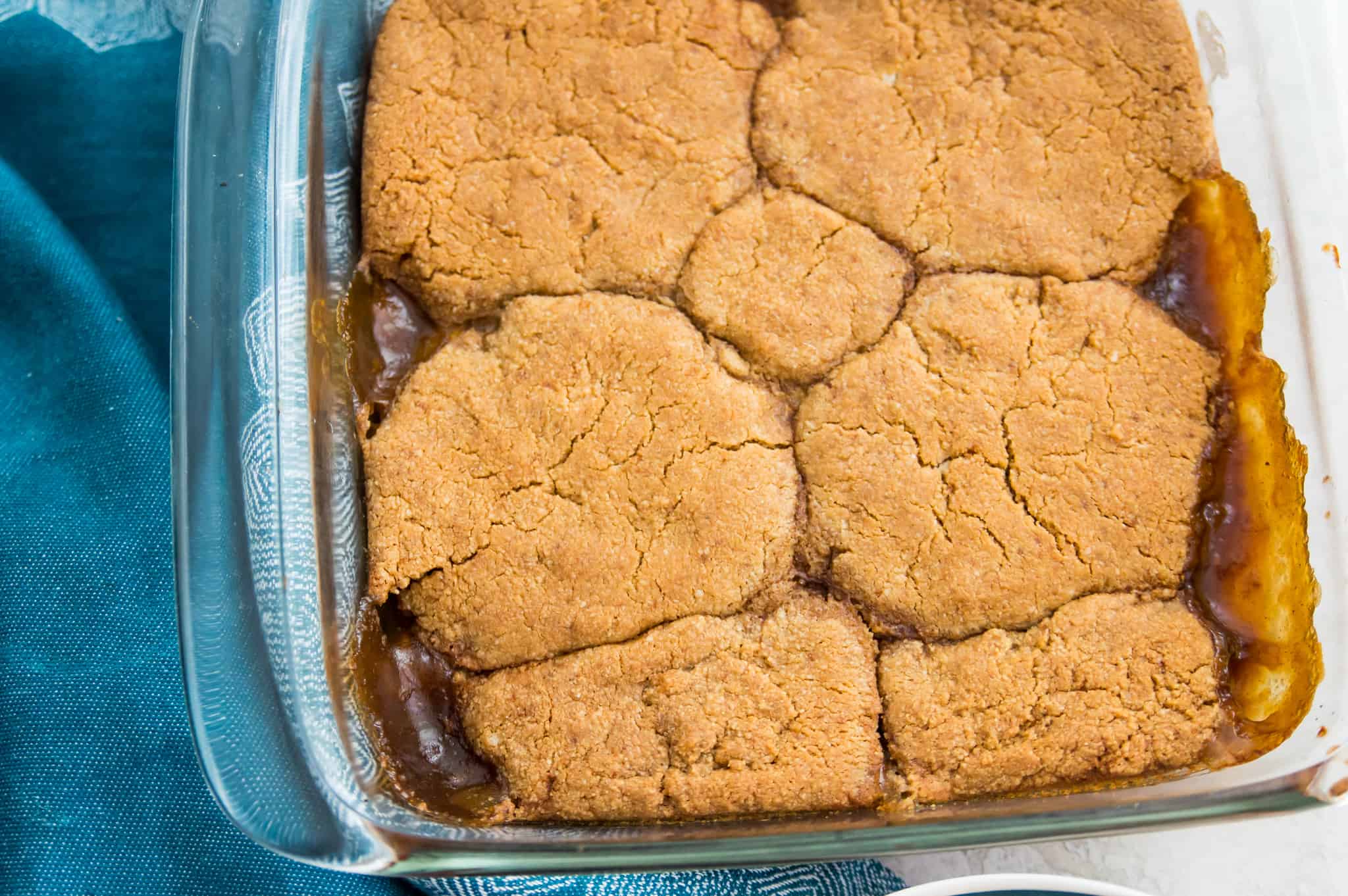 A baking dish with a peach cobbler in it.