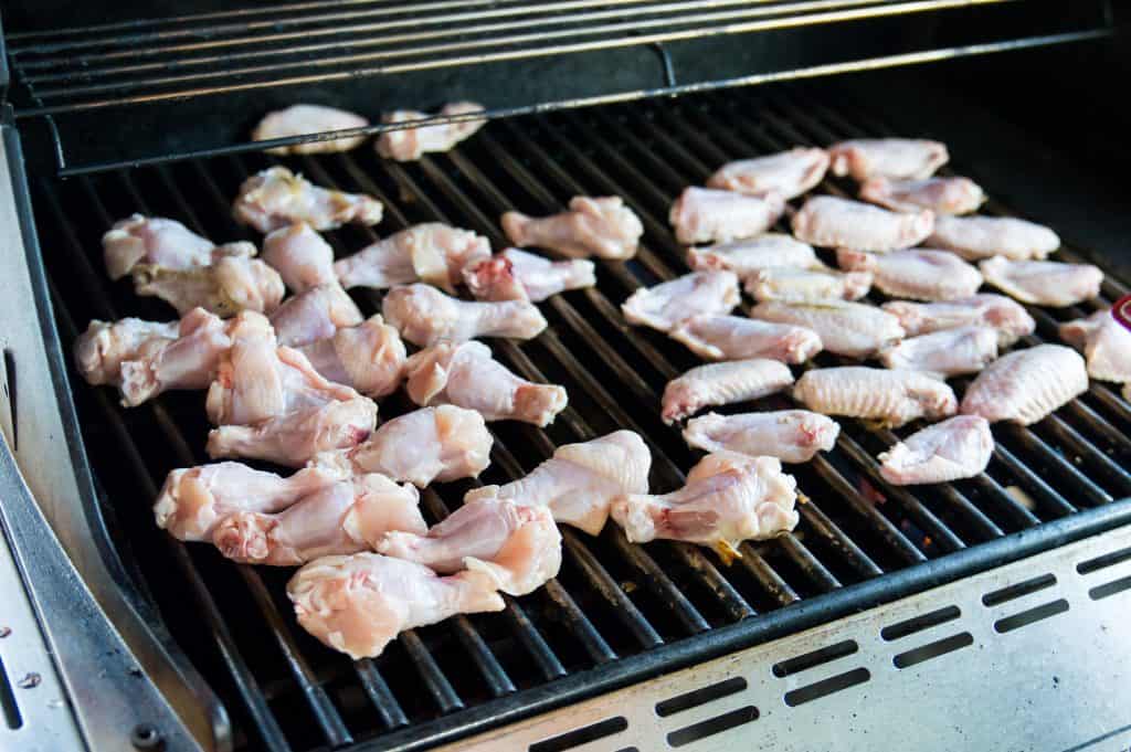 Chicken wings being cooked a grill.