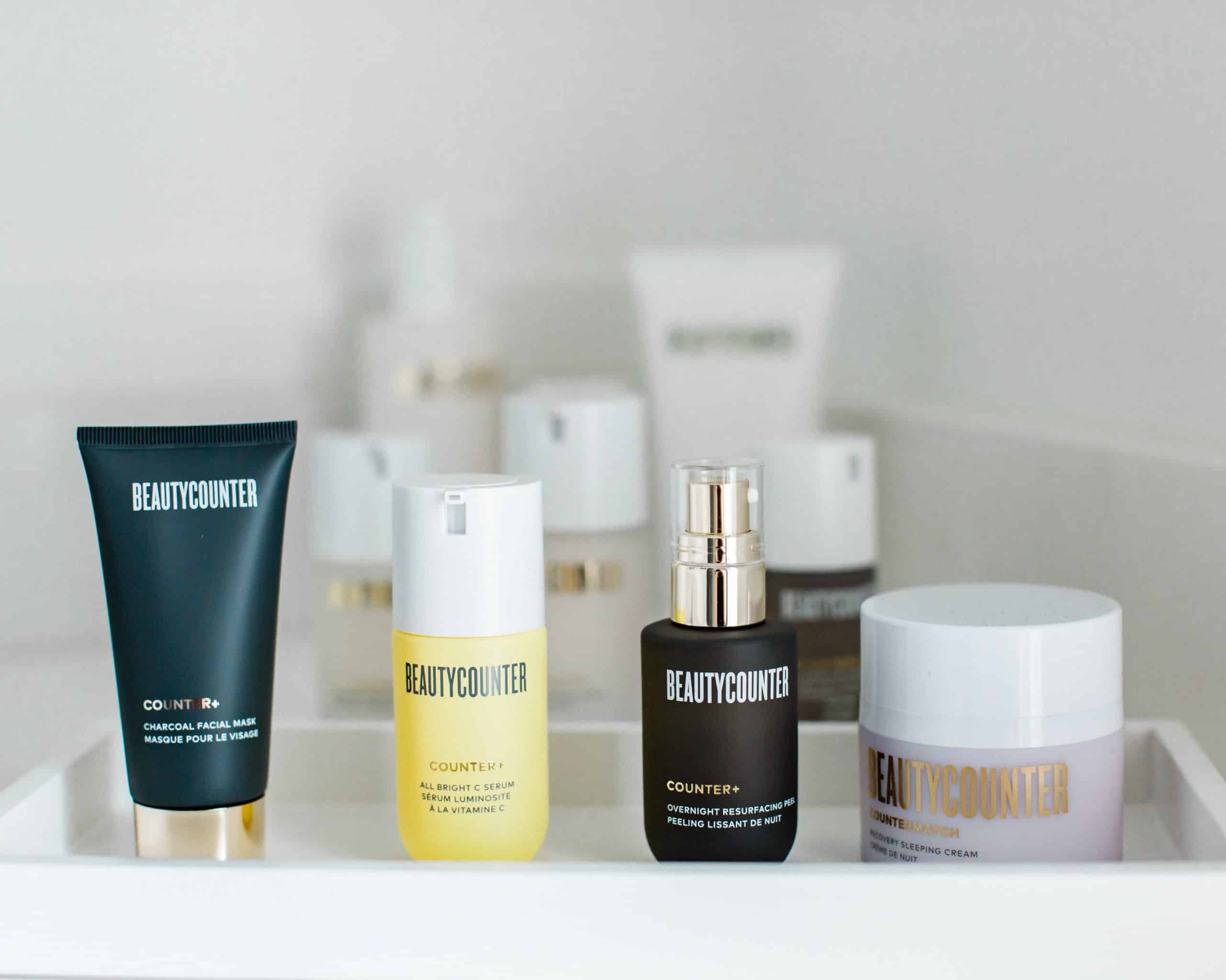 A tray of Beautycounter products including charcoal mask, vitamin C serum and overnight peel.