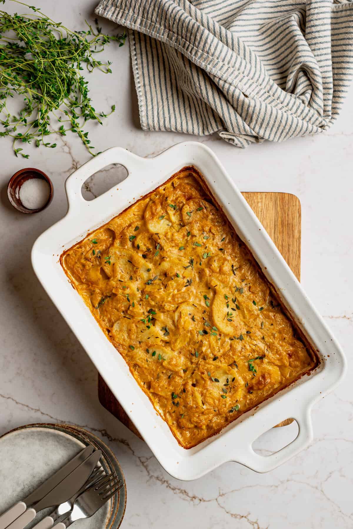 A casserole dish filled with cooked scalloped potatoes.