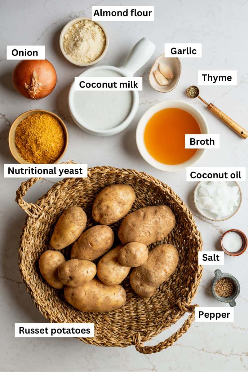The ingredients needed to make dairy free scalloped potatoes in separate bowls including potatoes, broth, coconut milk, onion, and spices.
