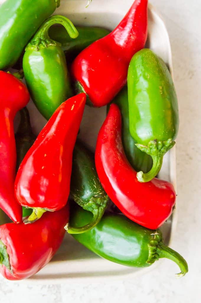 A basket full of red and green chili peppers