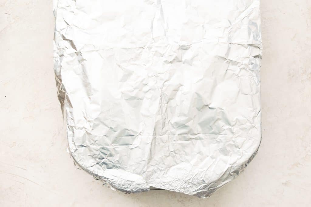 A baking dish covered in tinfoil.