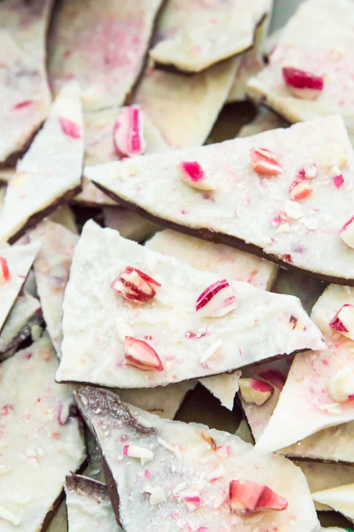 A pile of vegan peppermint bark pieces with crushed candy canes on top.
