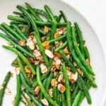 A plate of keto green beans topped with roasted slivered almonds.