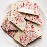 Pieces of vegan peppermint bark topped with crushed candy canes.