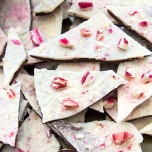 Pieces of vegan peppermint bark topped with crushed candy canes.