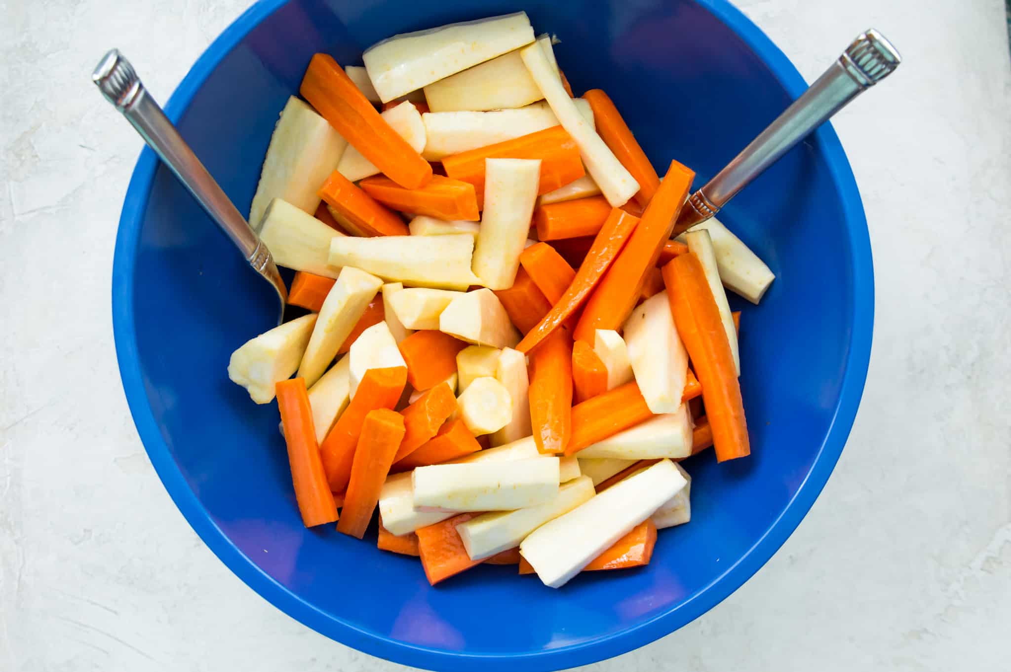 A bowl of chopped carrots and parsnips. 