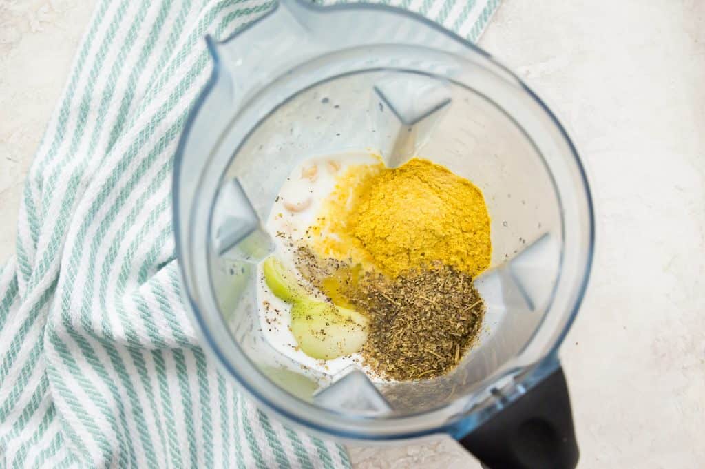 Cashews, water, coconut milk, chopped onion and spices in a blender.