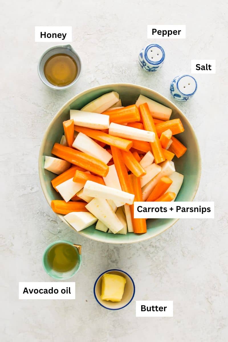 Bowls filled with different foods including honey, butter, carrots, parsnips and avocado oil.