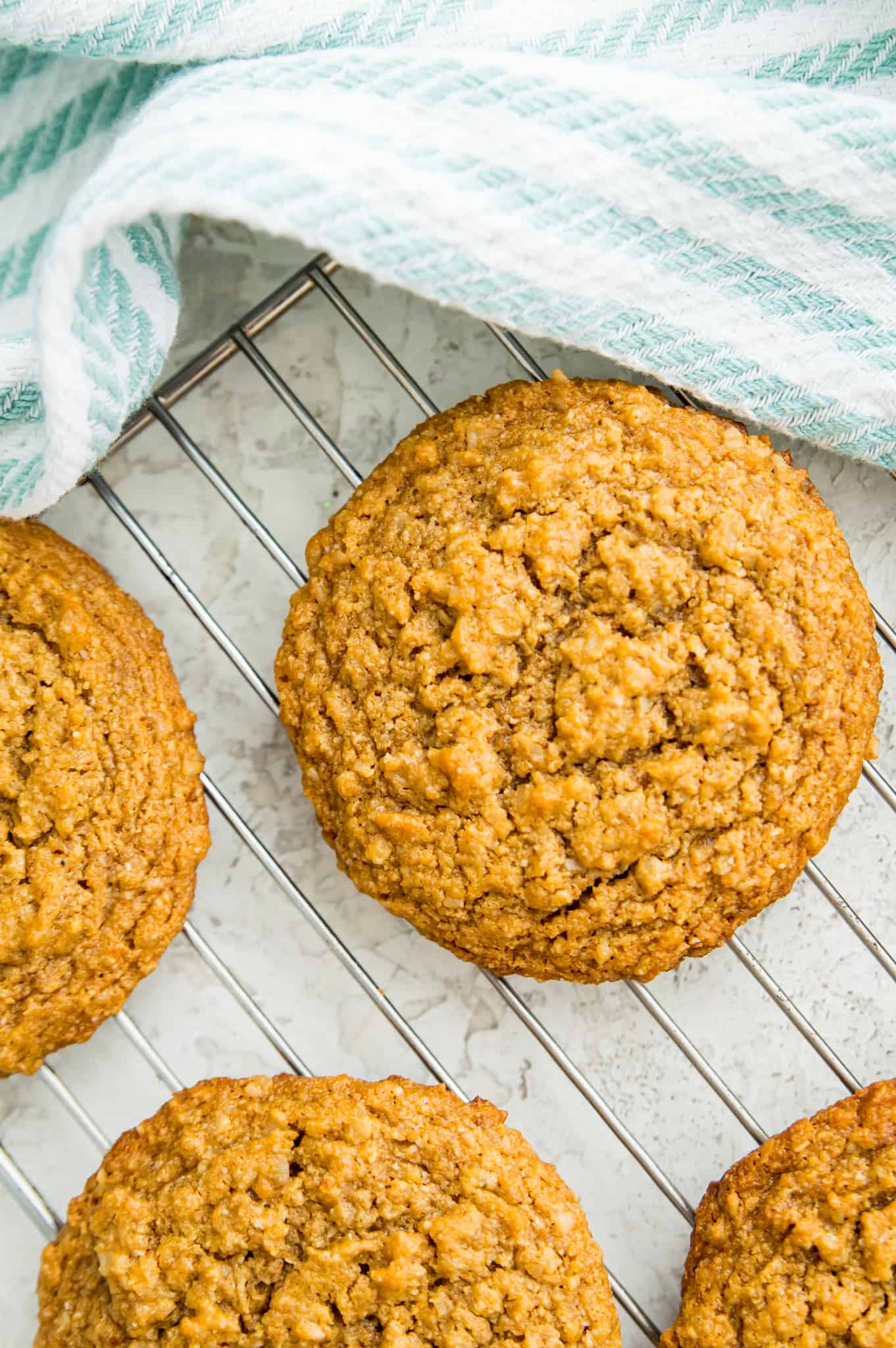 A baking rack with vegan oatmeal peanut butter cookies on it.