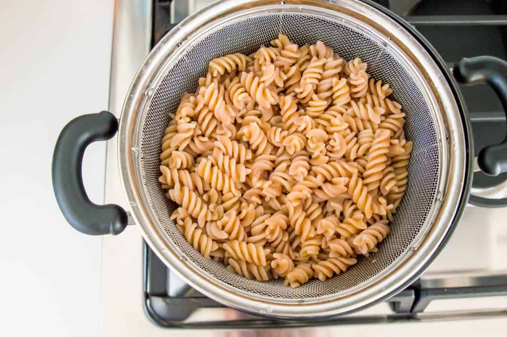 Cooked pasta draining in a colander. 