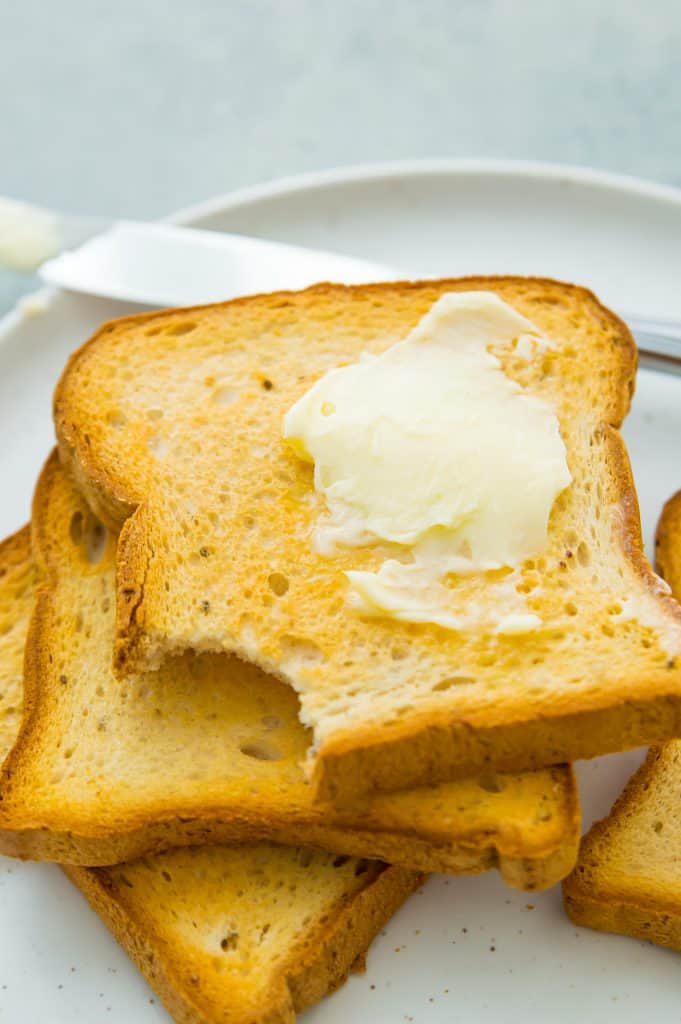 A stack of air fryer toast with melted butter on top