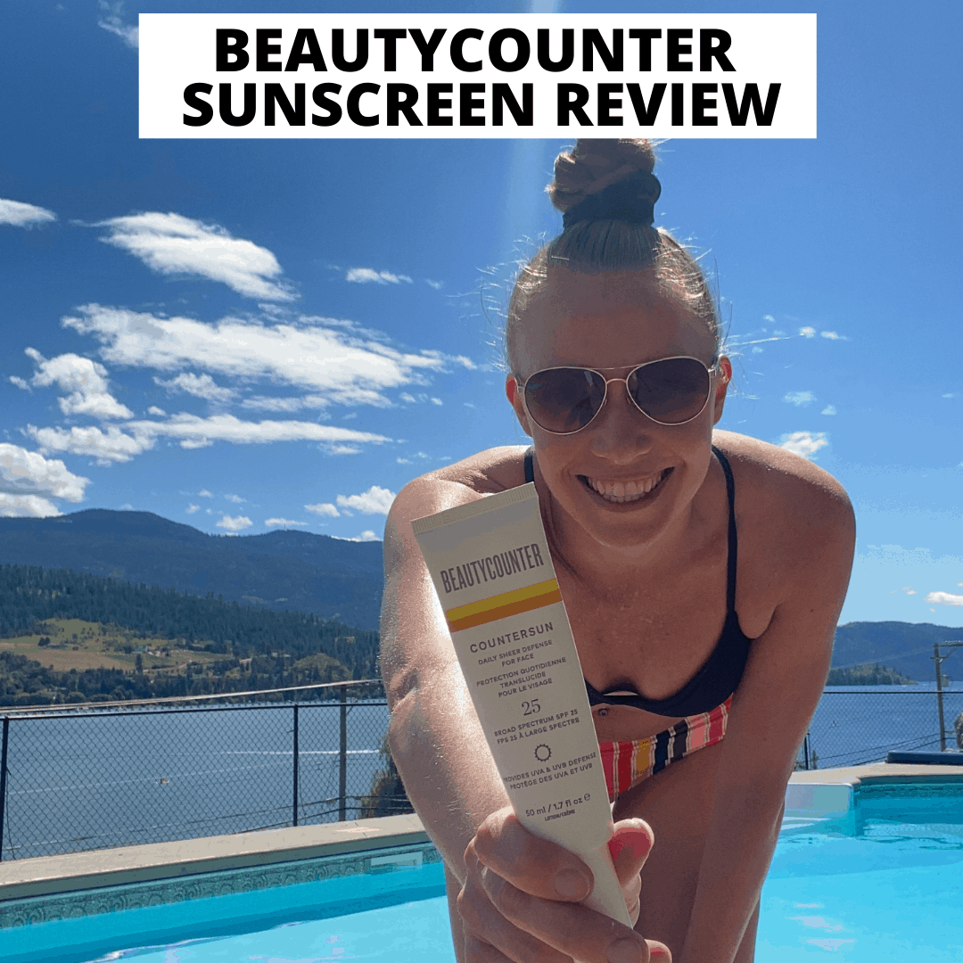 A girl in a bikini holding a Beautycounter sunscreen beside a pool.