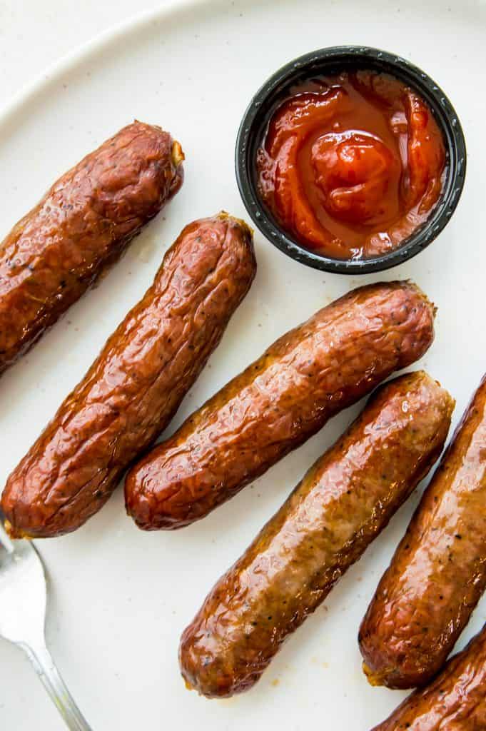 Sausages cooked in an air fryer Sausages cooked in an air fryer on a plate with ketchup